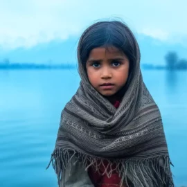 Indian girl freezing near Dal lake